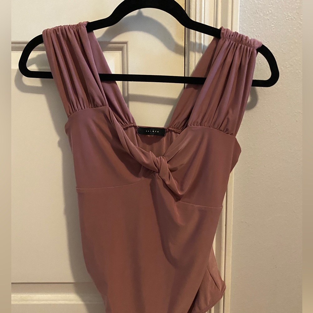 Saints bodysuit. Mauvy/purple color with a knot design in the front.
